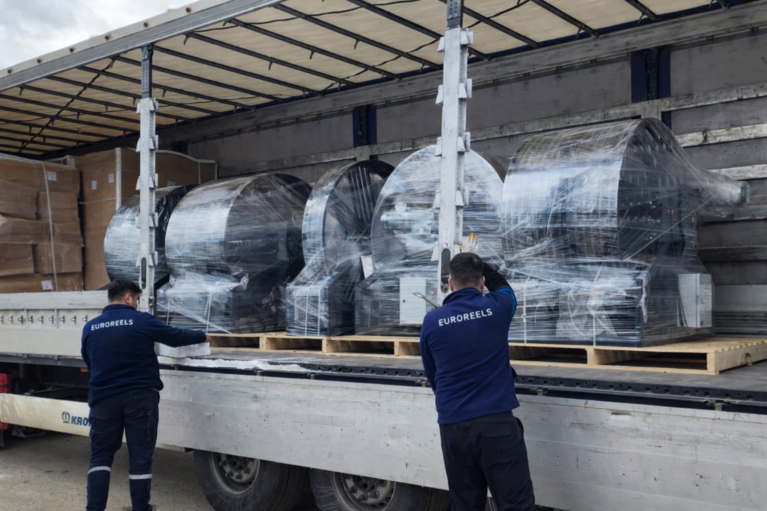 Large cable reel systems prepared for shipment as generator trailer components